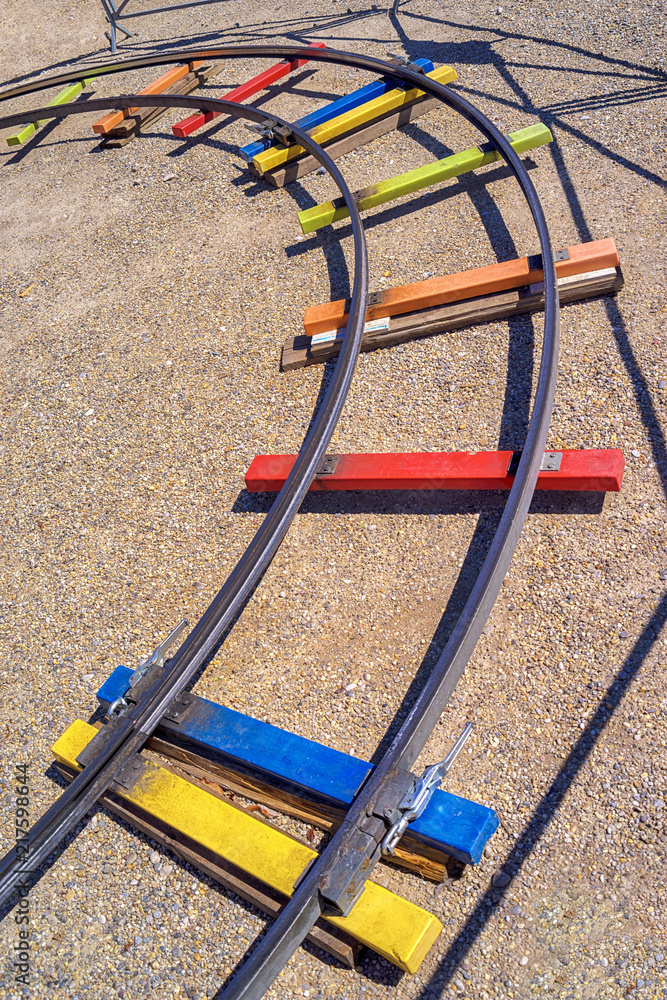 Rails of a fun train.Colorful coaster rails in an amusement park Rails of a fun train.Colorful coaster rails in an amusement park