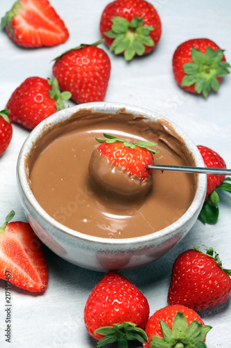 Fondue with Melting chocolate or melted chocolate and strawberry.