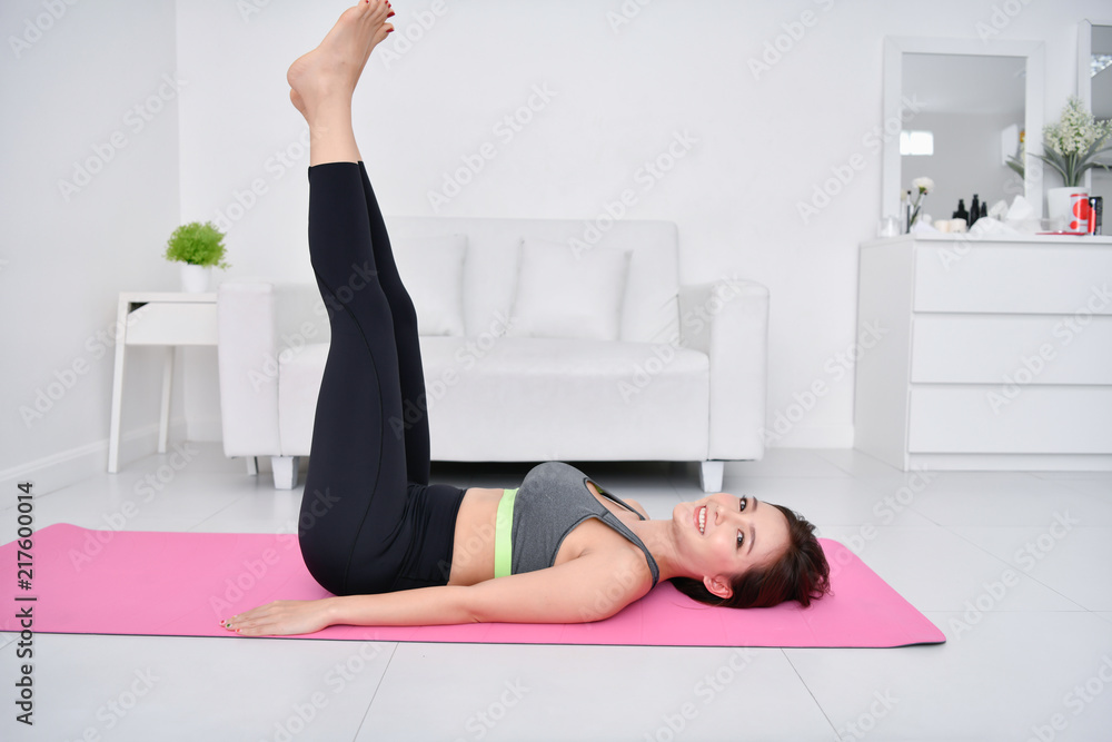 Concept of exercise. Beautiful girl is exercising in her house. Beautiful girl takes good care of her health. Concept of exercise. Beautiful girl is exercising in her house. Beautiful girl takes good care of her health.