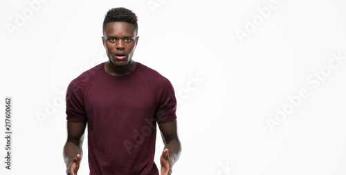 Young african american man scared in shock with a surprise face, afraid and excited with fear expression