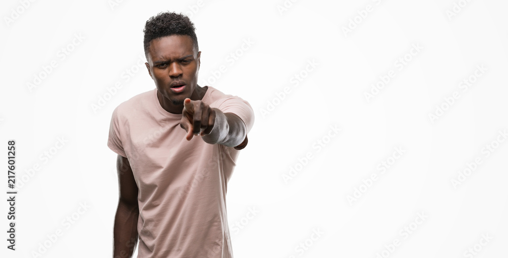 Young african american man pointing with finger to the camera and to you, hand sign, positive and confident gesture from the front Young african american man pointing with finger to the camera and to you, hand sign, positive and confident gesture from the front