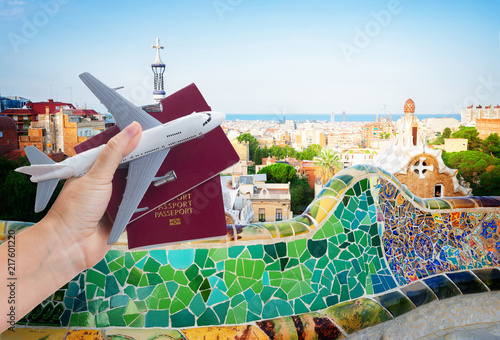 Photography travel to Spain concept, hand holding passports with plane isolated on white bac