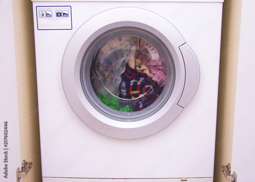 Front view of a washing machine drum during cleaning clothes Front view of a washing machine drum during cleaning clothes