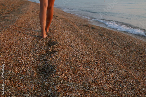 girls legs walking on beach