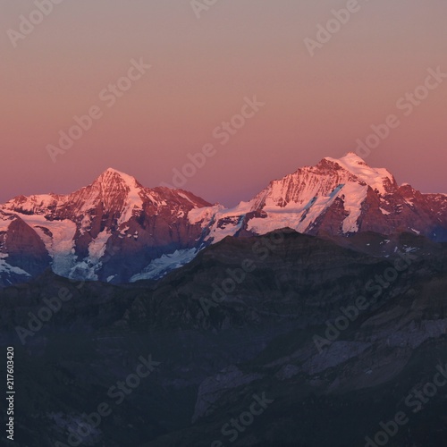 Famous mountains Monch and Jungfrau at sunset. View from Mount Niesen. Bernese Oberland, Switzerland.
