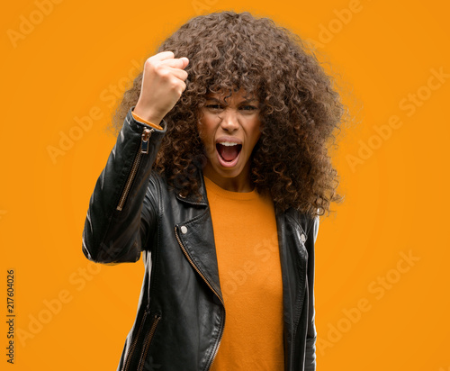 African american woman wearing a leather jacket annoyed and frustrated shouting with anger, crazy and yelling with raised hand, anger concept © Krakenimages.com