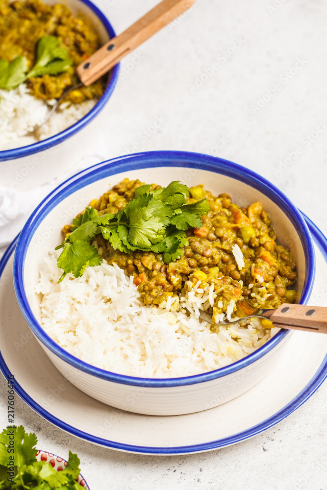 Lentil curry with rice, Indian cuisine, tarka dal, white background. Vegan food. Lentil curry with rice, Indian cuisine, tarka dal, white background. Vegan food.