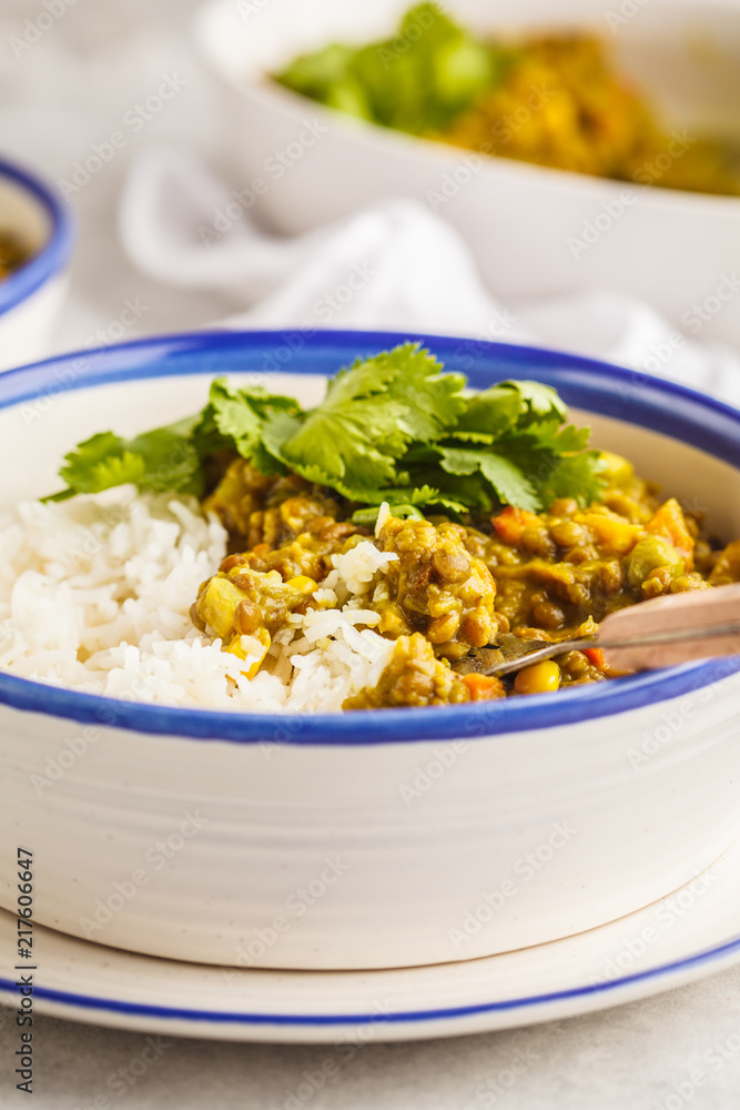 Lentil curry with rice, Indian cuisine, tarka dal, white background. Vegan food.