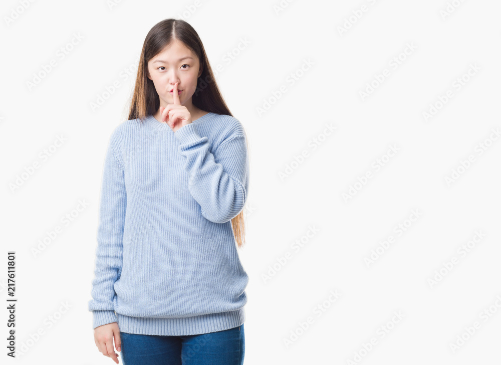Young Chinese woman over isolated background asking to be quiet with finger on lips. Silence and secret concept. Young Chinese woman over isolated background asking to be quiet with finger on lips. Silence and secret concept.