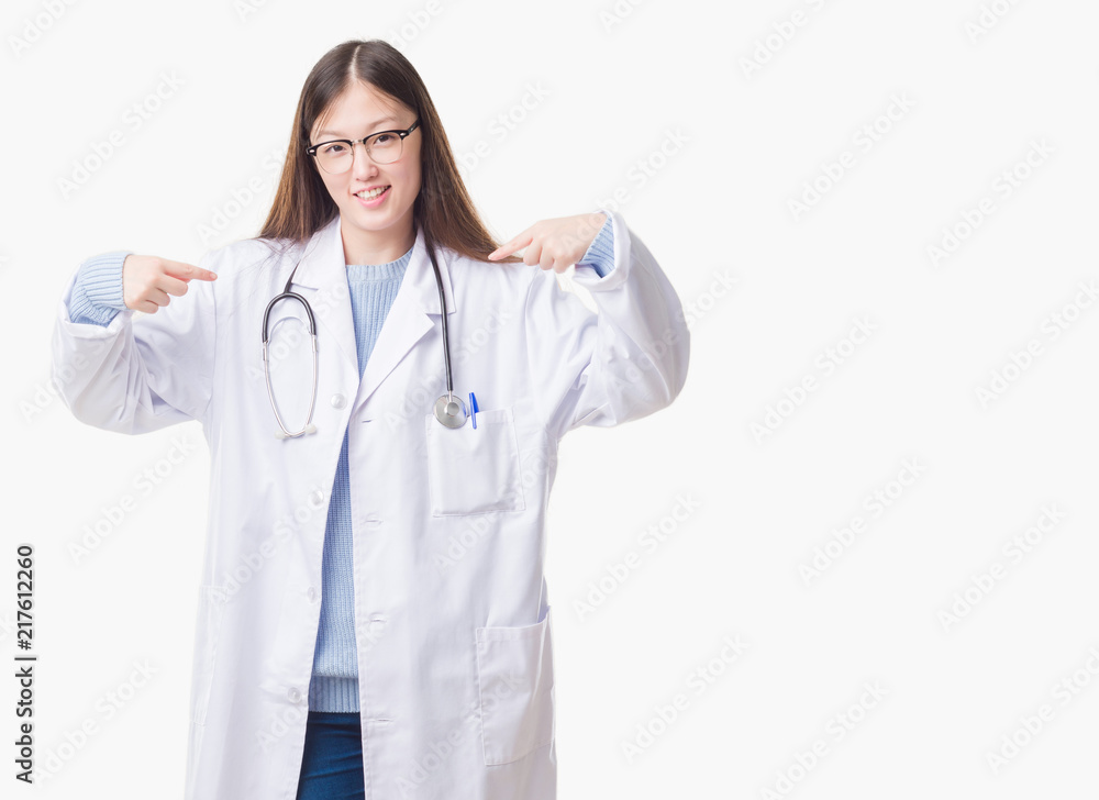 Young Chinese doctor woman over isolated background looking confident with smile on face, pointing oneself with fingers proud and happy. Young Chinese doctor woman over isolated background looking confident with smile on face, pointing oneself with fingers proud and happy.