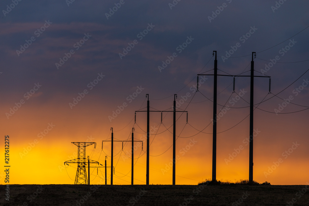 Rural landscape with high-voltage line on sunset
