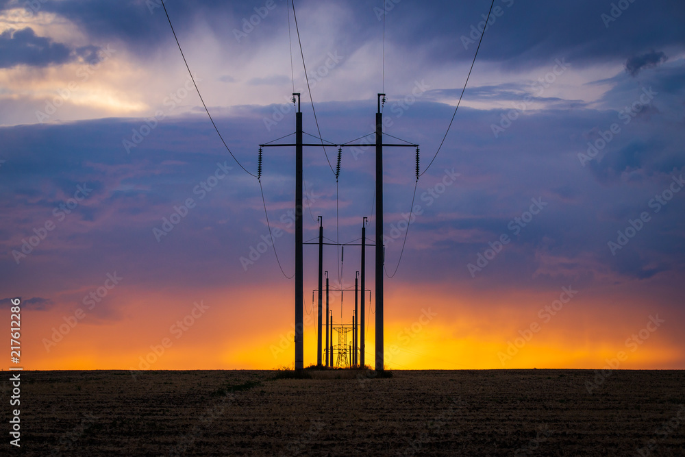 Rural landscape with high-voltage line on sunset