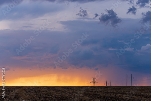 Obraz na płótnie Rural landscape with high-voltage line on sunset w salonie