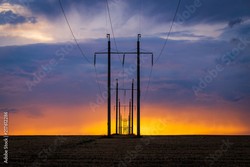 Obraz na płótnie Rural landscape with high-voltage line on sunset w salonie