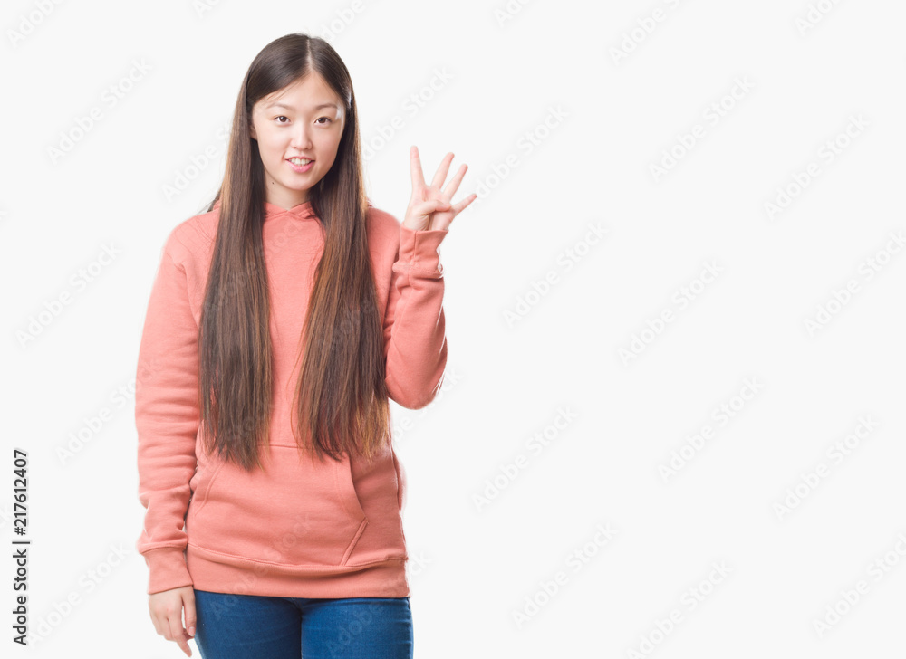 Young Chinese woman over isolated background wearing sport sweathshirt showing and pointing up with fingers number four while smiling confident and happy. Young Chinese woman over isolated background wearing sport sweathshirt showing and pointing up with fingers number four while smiling confident and happy.