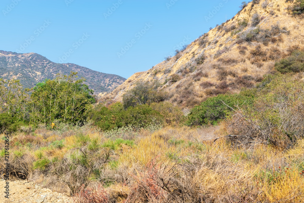 Dry brush and steep hillsides of Southern California mountains on hot summer day