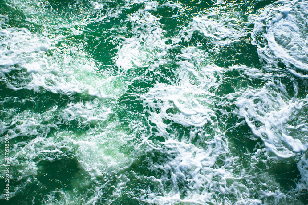 surface of turquoise ocean water with white foam, background, texture