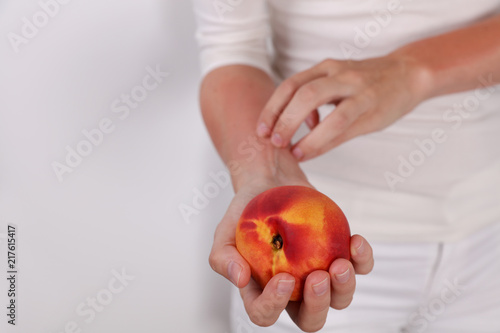 Принти на полотні Woman suffering from Fruit Allergy holding a peach