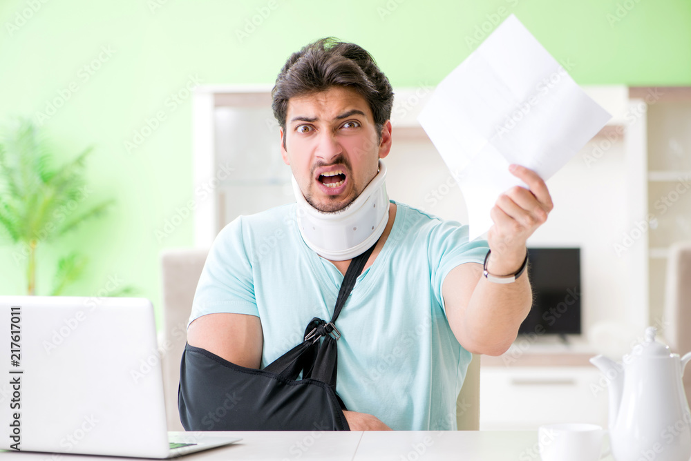 Young student man with neck and hand injury at home Young student man with neck and hand injury at home