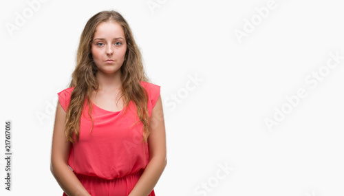 Young blonde woman wearing pink dress with a confident expression on smart face thinking serious © Krakenimages.com