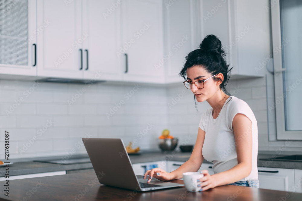 Beautiful young girl checking email on laptop Beautiful young girl checking email on laptop