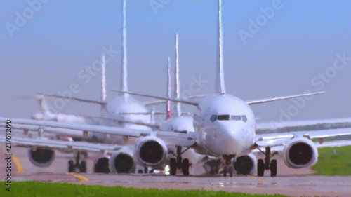 Multiple Airliners in queue on the runway. Standing in line to take off.
