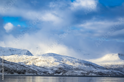 View on snowy mountain peaks during a winter storm