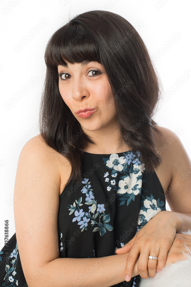 Attractive young woman smirking with her mouth because she has a secret surprise to tell Attractive young woman smirking with her mouth because she has a secret surprise to tell