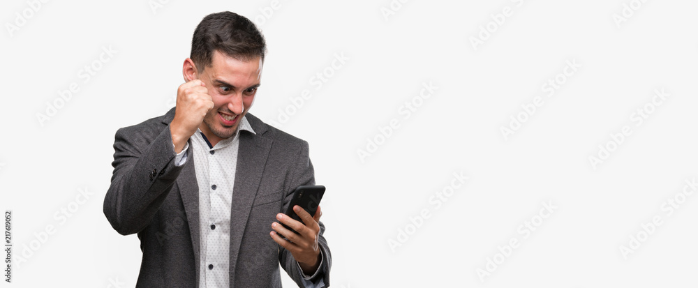Handsome young man using smartphone annoyed and frustrated shouting with anger, crazy and yelling with raised hand, anger concept Handsome young man using smartphone annoyed and frustrated shouting with anger, crazy and yelling with raised hand, anger concept