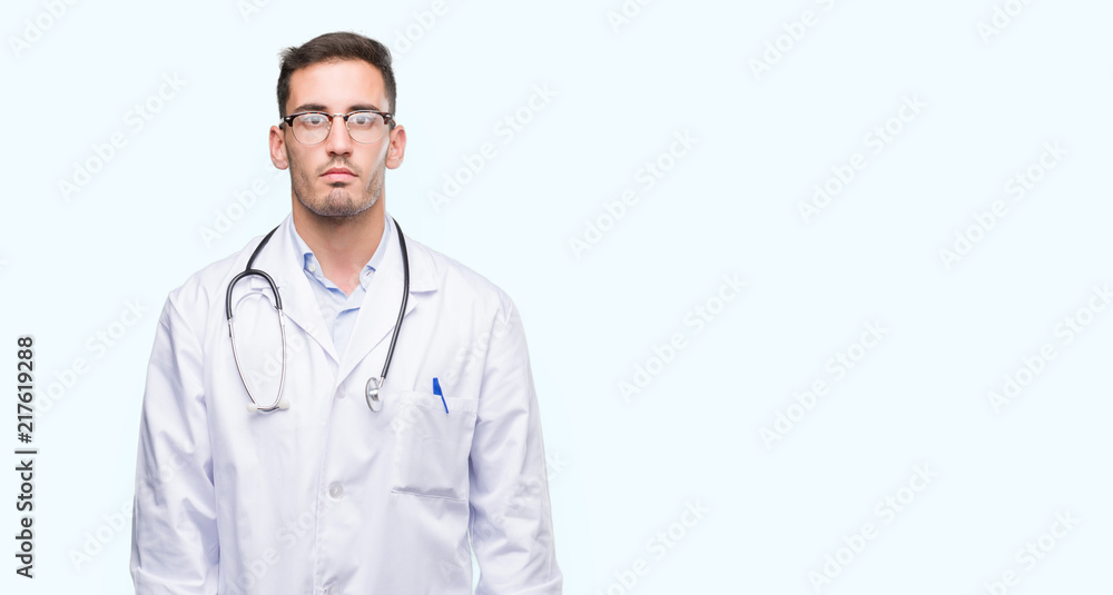 Handsome young doctor man with serious expression on face. Simple and natural looking at the camera. Handsome young doctor man with serious expression on face. Simple and natural looking at the camera.