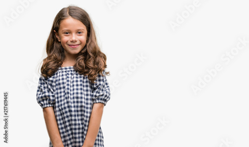 Brunette hispanic girl wearing black and white dress with a happy face standing and smiling with a confident smile showing teeth © Krakenimages.com