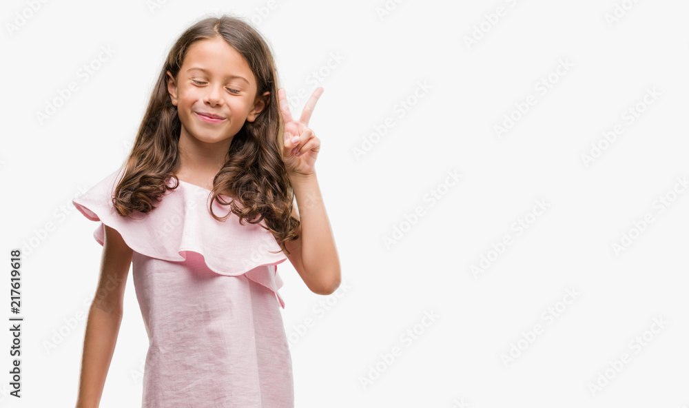 Brunette hispanic girl wearing pink dress showing and pointing up with fingers number two while smiling confident and happy. Brunette hispanic girl wearing pink dress showing and pointing up with fingers number two while smiling confident and happy.