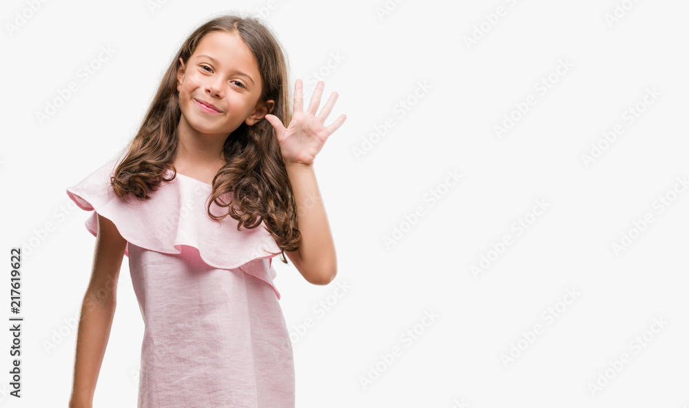 Brunette hispanic girl wearing pink dress showing and pointing up with fingers number five while smiling confident and happy. Brunette hispanic girl wearing pink dress showing and pointing up with fingers number five while smiling confident and happy.