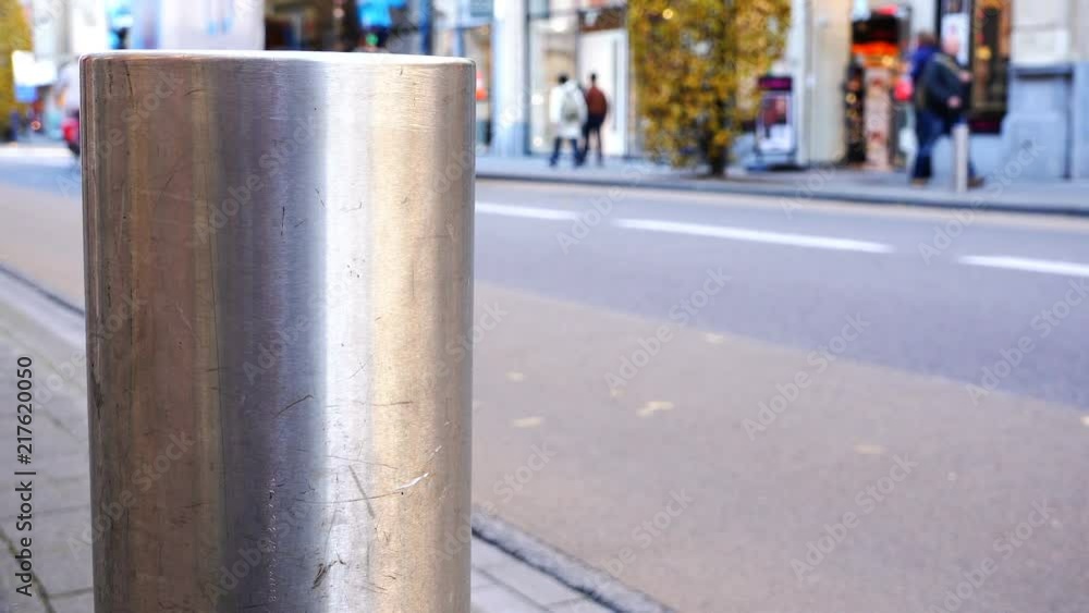 metal pillar, divides the roadway and pedestrian section.