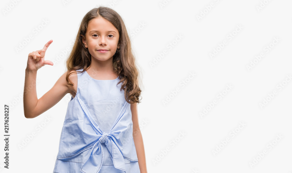 Brunette hispanic girl smiling and confident gesturing with hand doing size sign with fingers while looking and the camera. Measure concept. Brunette hispanic girl smiling and confident gesturing with hand doing size sign with fingers while looking and the camera. Measure concept.