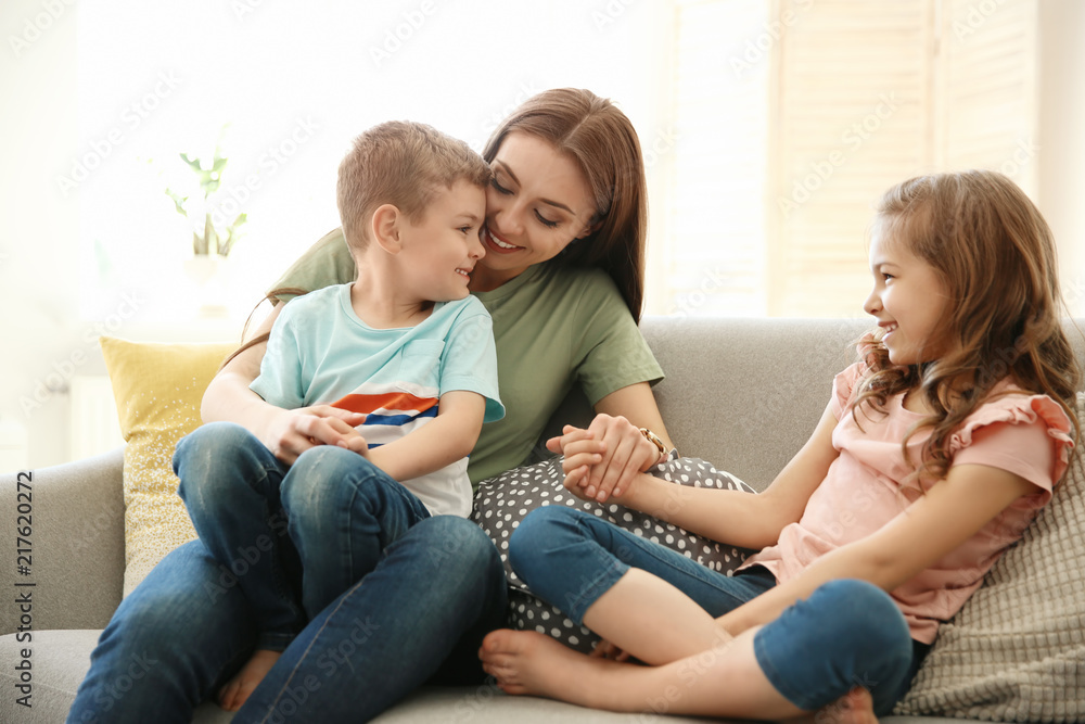 Young woman spending time with her children at home. Happy family Young woman spending time with her children at home. Happy family