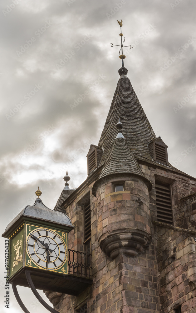 Edinburgh, Scotland, UK - June 12, 2012: Closeup of the clock tower of Brown stone People’s Story Museum under heavy stormy sky. Previously Tolbooth.