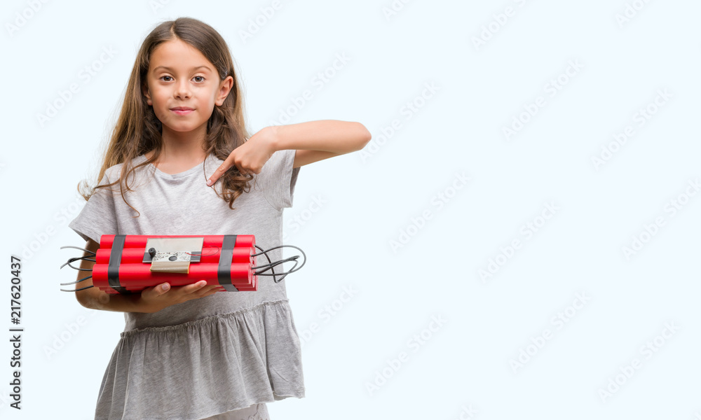 Brunette hispanic girl holding a bomb with surprise face pointing finger to himself Brunette hispanic girl holding a bomb with surprise face pointing finger to himself