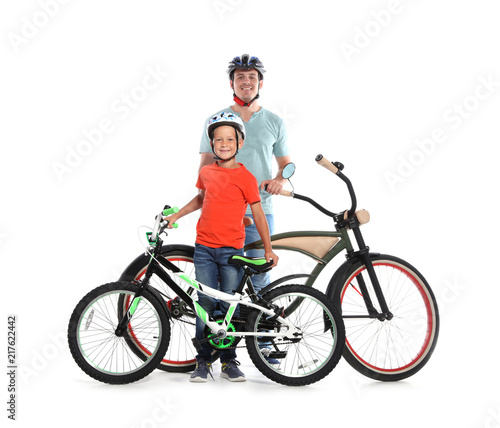 Portrait of father and his son with bicycles on white background