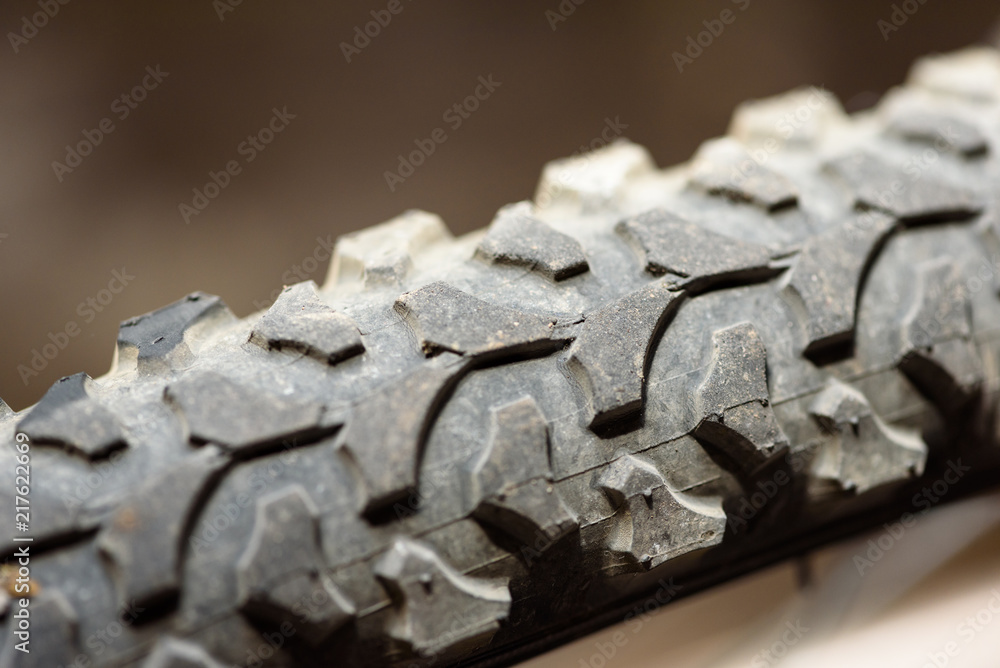 Closeup macro image of a bikes rear wheel with rubber tread detail in natural sunlight and a copyspace area for cycling adventure mountain bike ideas Closeup macro image of a bikes rear wheel with rubber tread detail in natural sunlight and a copyspace area for cycling adventure mountain bike ideas