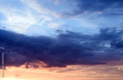 Dramatic stormy clouds with abeautiful amazing colors and a sunset with no landscape in this cloudscape