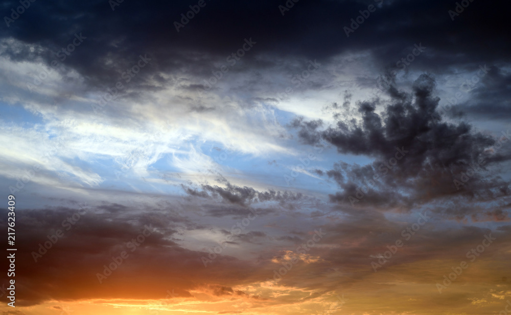 Dramatic stormy clouds with abeautiful amazing colors and a sunset with no landscape in this cloudscape