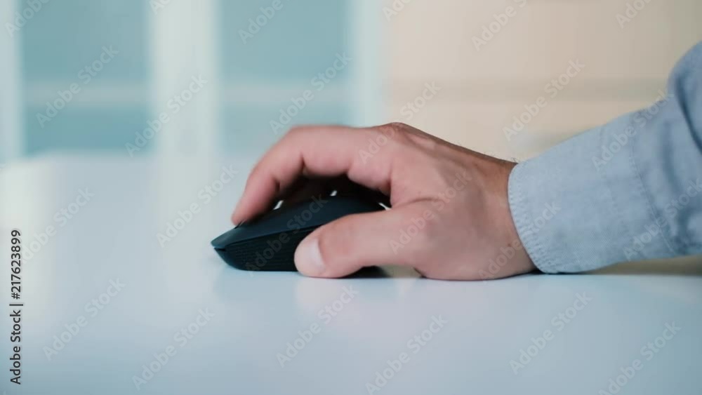 Side view on man hand using computer mouse, working in the office, close up on hands, work concept, 4K UHD Side view on man hand using computer mouse, working in the office, close up on hands, work concept, 4K UHD