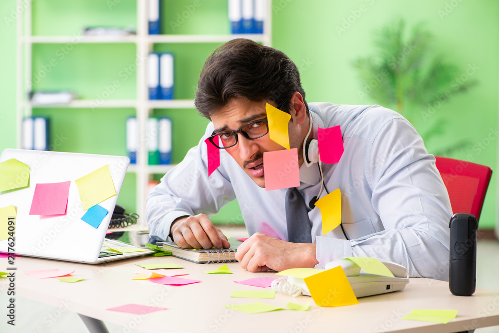 Young help desk operator working in office with many conflicting Young help desk operator working in office with many conflicting