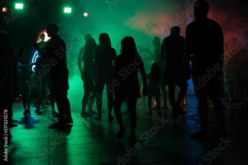 Wallpaper Mural People dance at a nightclub at night in silhouette with different color lights and digital effects Torontodigital.ca