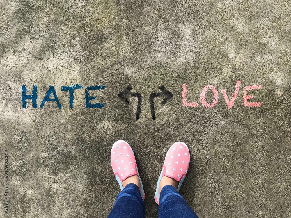 Hate or Love arrow and pink slipper shoe on concrete background Hate or Love arrow and pink slipper shoe on concrete background