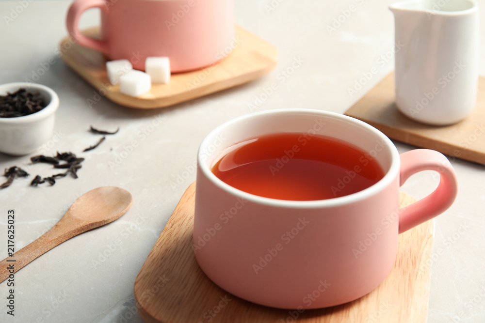 Cup of black tea on table, closeup