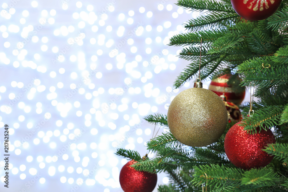 Christmas tree with festive decor against blurred fairy lights Christmas tree with festive decor against blurred fairy lights