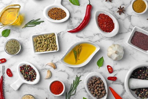 Flat lay composition with different aromatic spices on marble background
