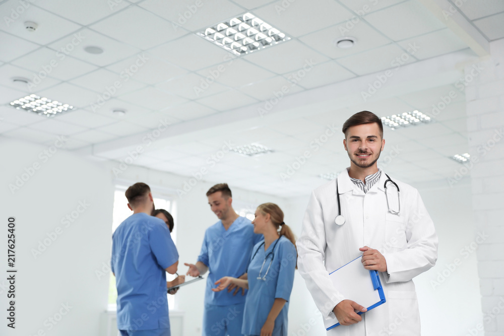 Portrait of male doctor and his colleagues at workplace Portrait of male doctor and his colleagues at workplace